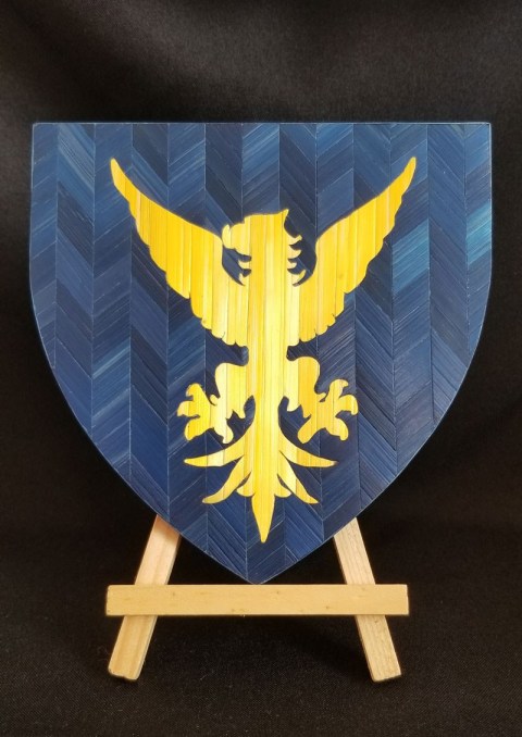 Blason d'Azur à une Aigle d'Or en marqueterie de paille