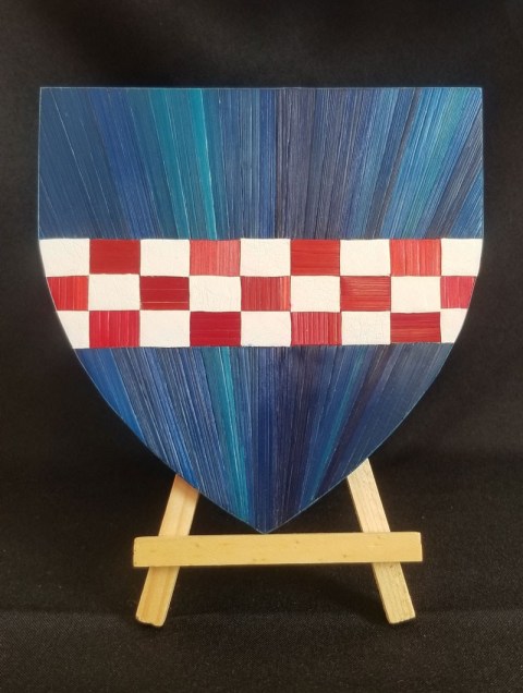 Blason d'Azur à un Echiqueté d'Argent et de Gueule en marqueterie de paille